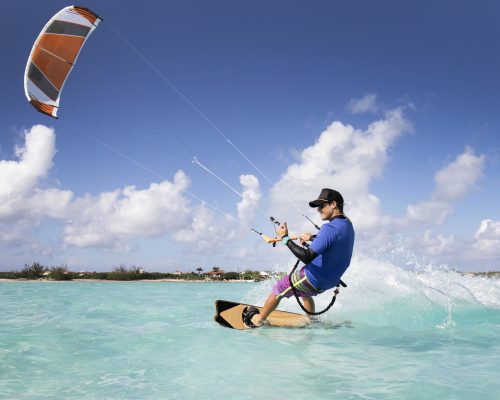 A man kite surfing in the Caribbean.